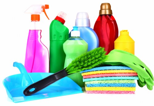 Cleaner preparing a UK property cleaning booking terms document